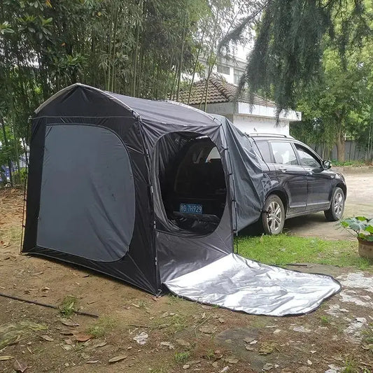 Portable camping tent attached to the side of an SUV.