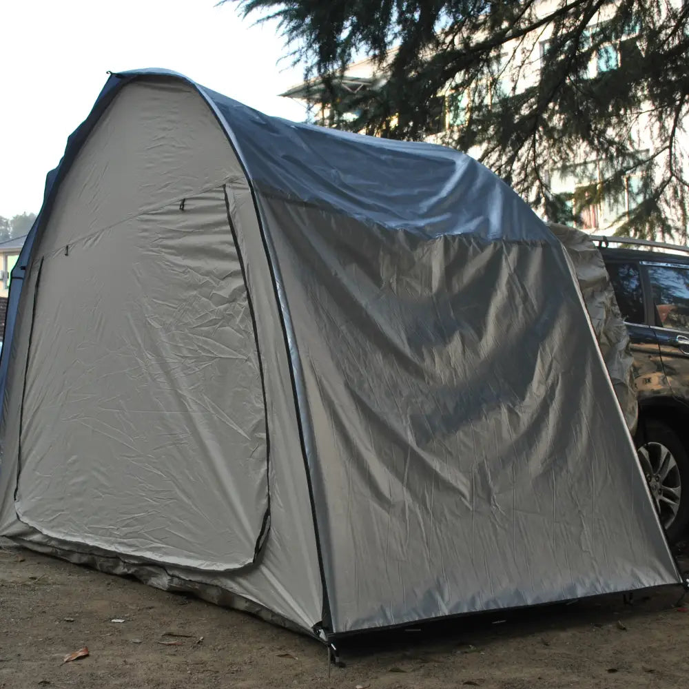 Gray canvas tent with a curved roof structure.