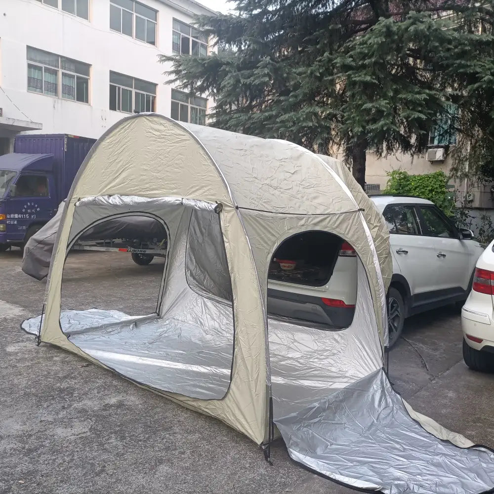 Portable tent-like structure covering a parked car.