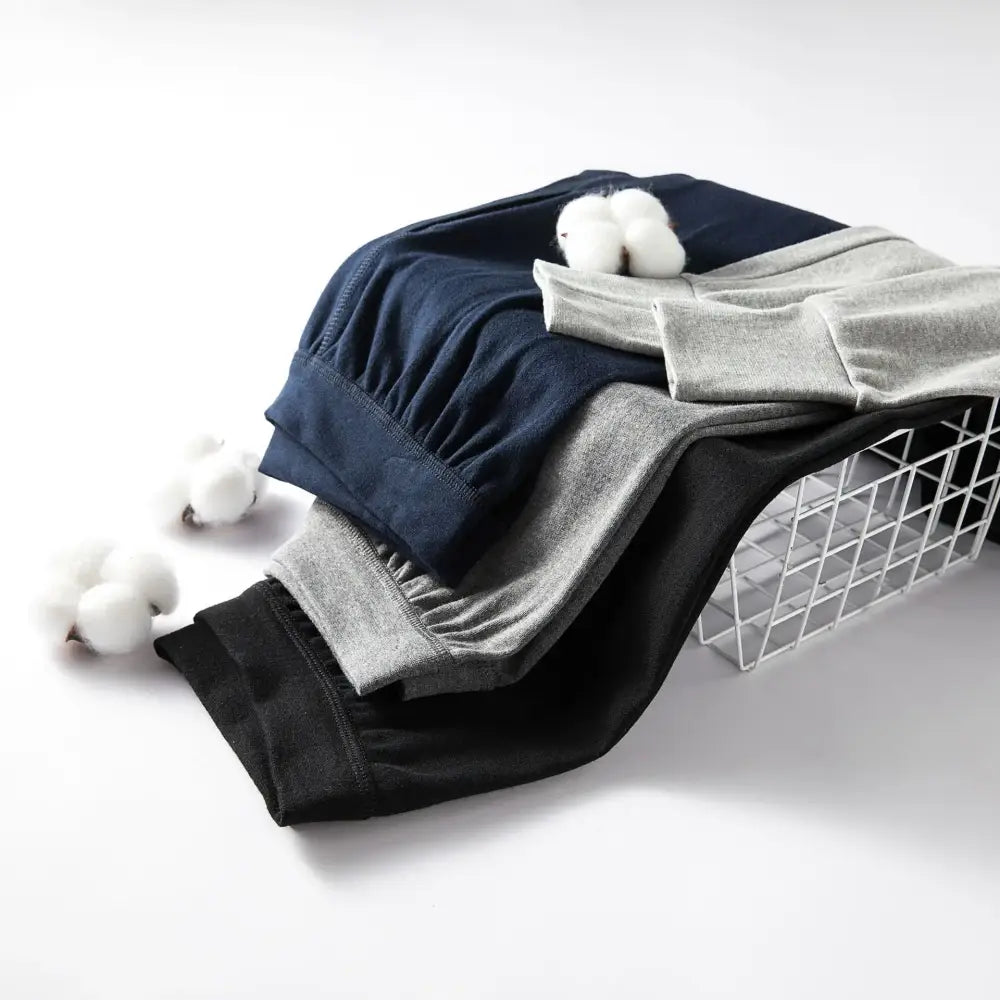 Wire laundry basket filled with folded clothes and cotton balls.