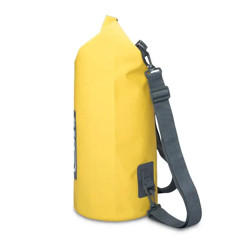 Yellow waterproof dry bag with a gray shoulder strap.