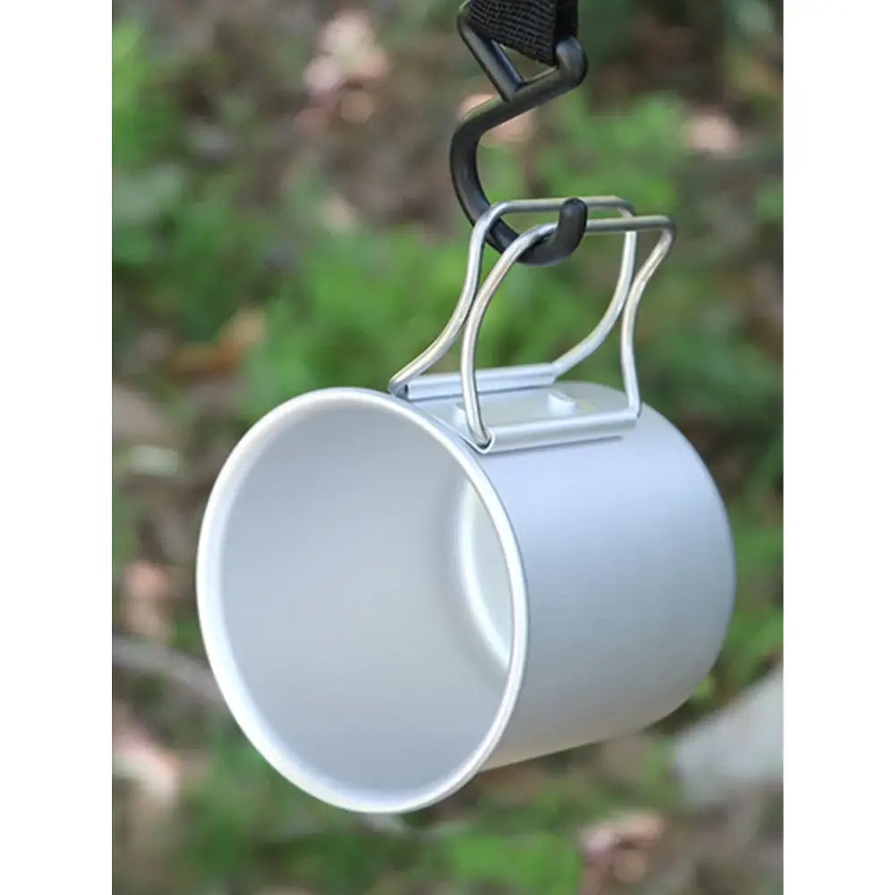 White enamel mug hanging from a hook.