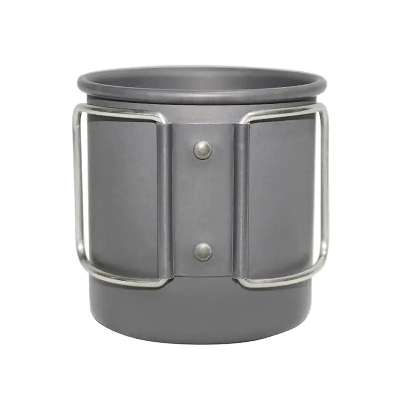 Titanium camping mug with folding handles and rivets.