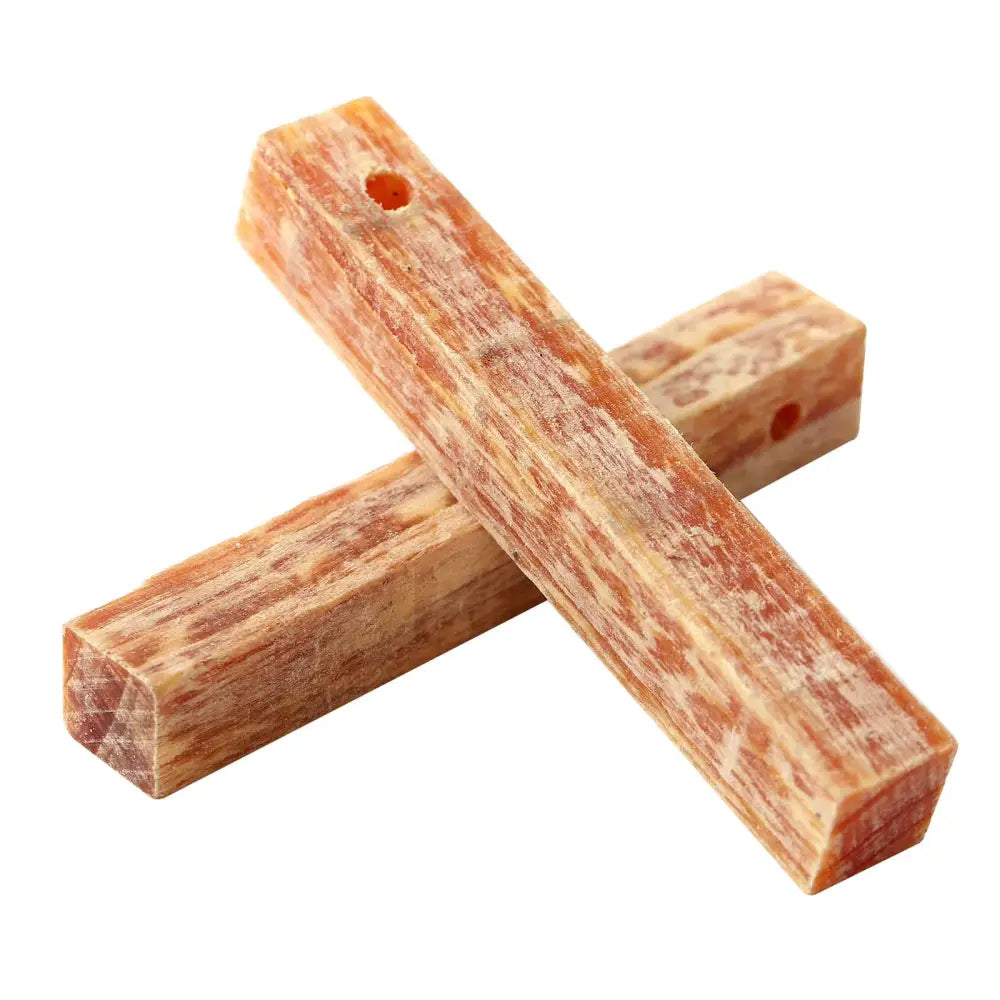 Dog chew sticks made from compressed rawhide or animal hide.