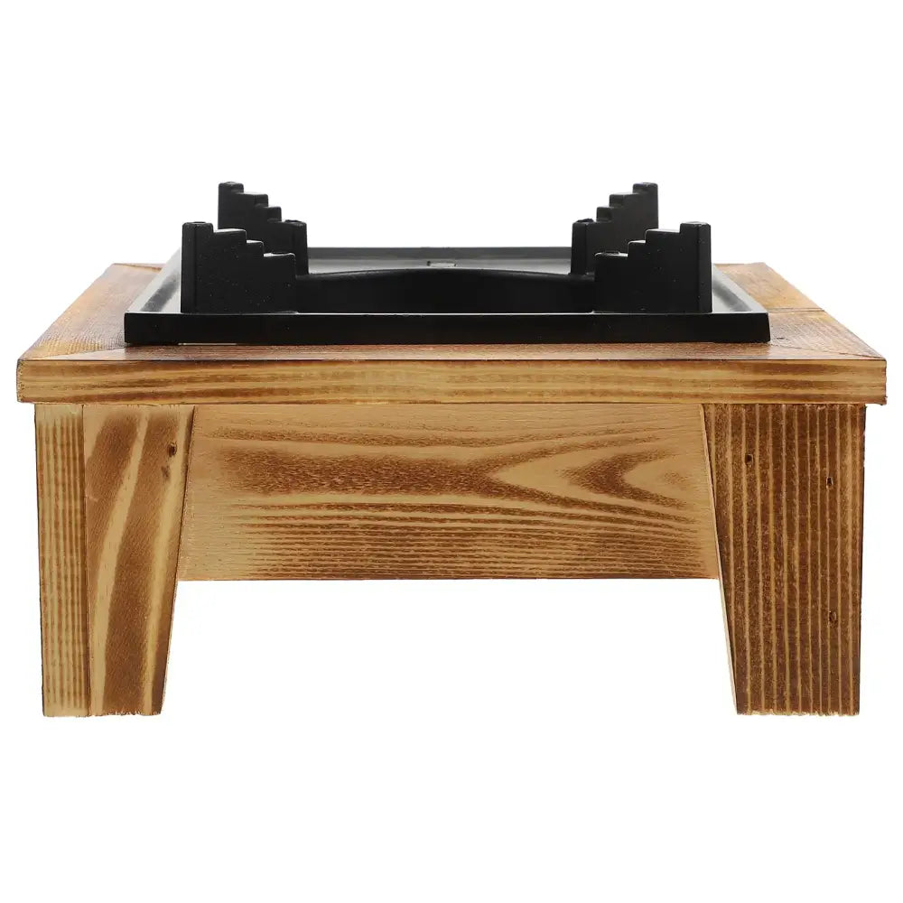 Wooden meditation bench with a black cushioned seat.