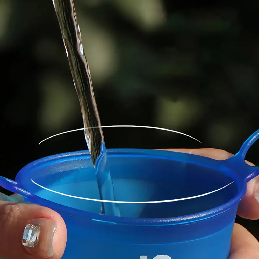 Blue plastic cup being filled with water.