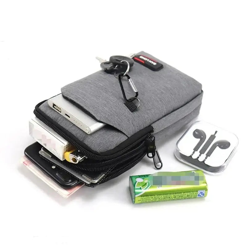 Gray fabric pouch or bag with multiple compartments and attached accessories.